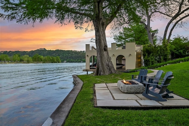 view of dock featuring a water view and a fire pit