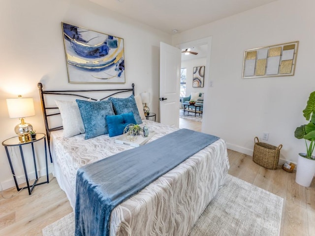 bedroom featuring baseboards and wood finished floors