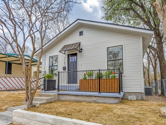 view of front facade with crawl space, central air condition unit, and fence