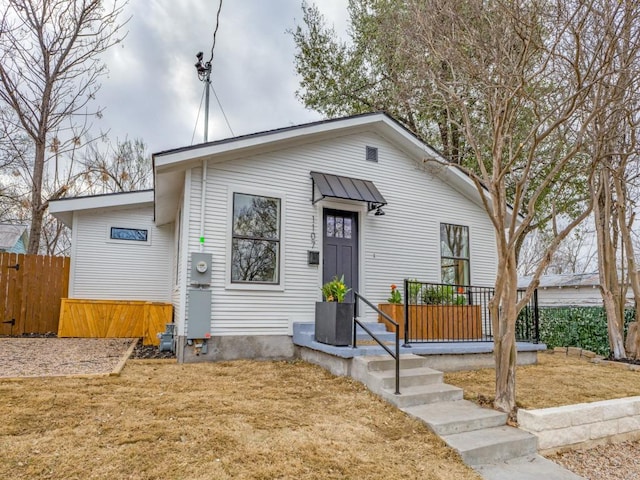 view of front of property with a front yard and fence