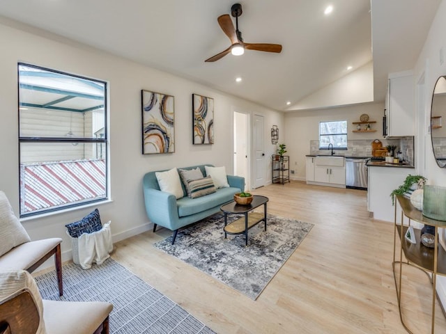 living room with baseboards, lofted ceiling, light wood-style flooring, recessed lighting, and ceiling fan