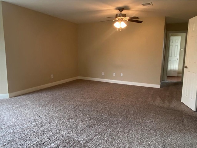 empty room with visible vents, baseboards, and a ceiling fan