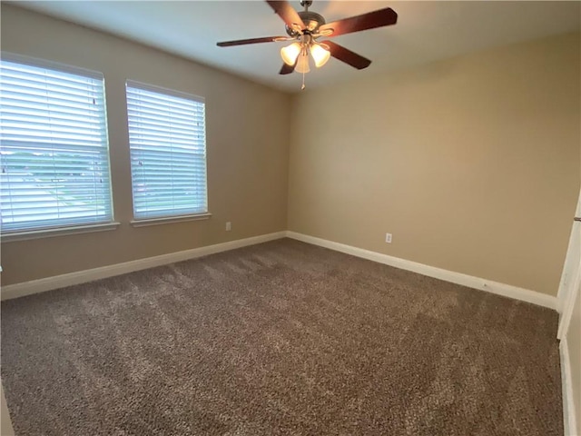 unfurnished room featuring ceiling fan, baseboards, and dark colored carpet