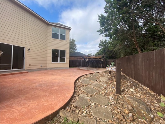 view of yard featuring a patio area and a fenced backyard