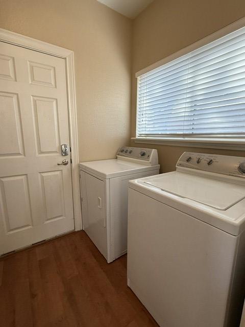 laundry area with laundry area, independent washer and dryer, and light wood finished floors