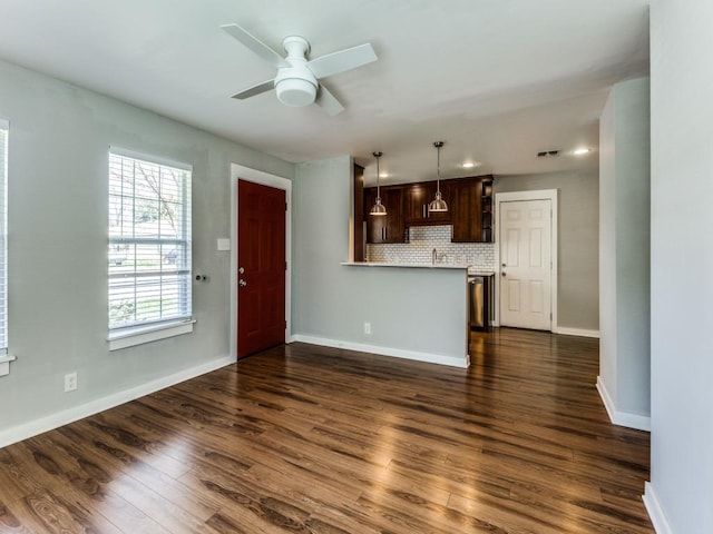 1105 Brookswood Ave, Austin, TX 78721 - unfurnished living room featuring a ceiling fan, dark wood finished floors, and recessed lighting
