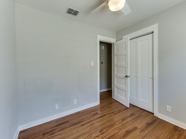 1105 Brookswood Ave, Austin, TX 78721 - unfurnished bedroom featuring wood finished floors, a closet, and ceiling fan