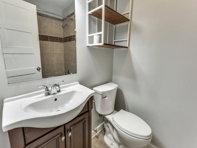 full bathroom with baseboards, toilet, vanity, and walk in shower