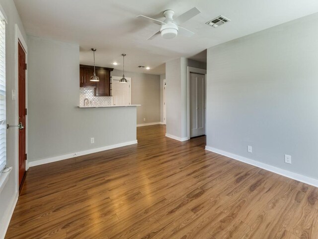 1105 Brookswood Ave, Austin, TX 78721 - unfurnished living room with a ceiling fan, wood finished floors, and recessed lighting