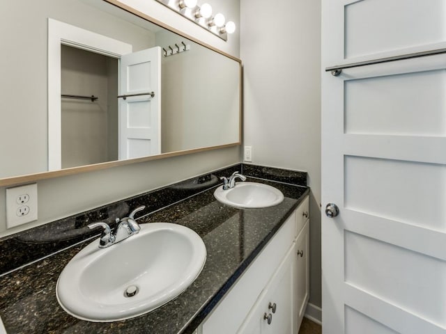 bathroom featuring a sink and double vanity