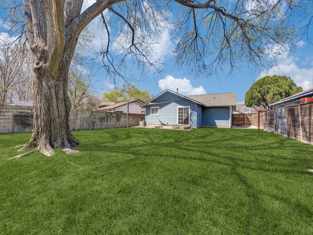 view of yard with a fenced backyard