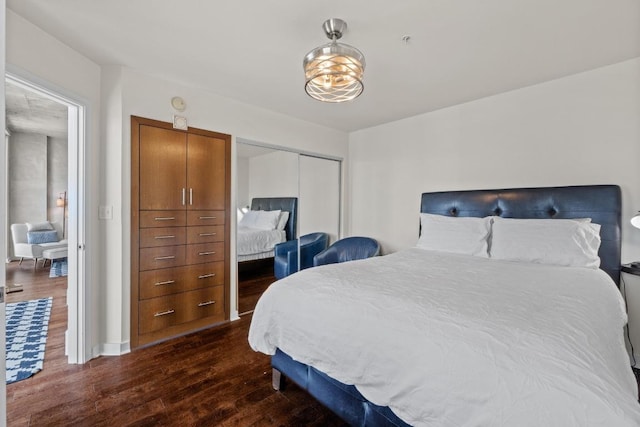 bedroom featuring a closet, baseboards, and dark wood-type flooring