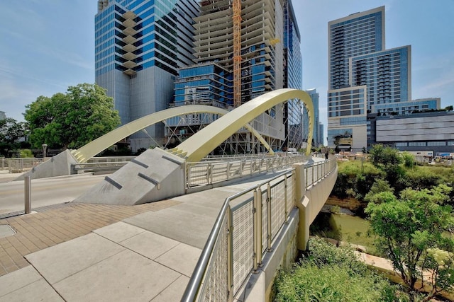 view of building exterior with a view of city and fence