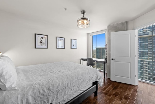 bedroom with dark wood-type flooring