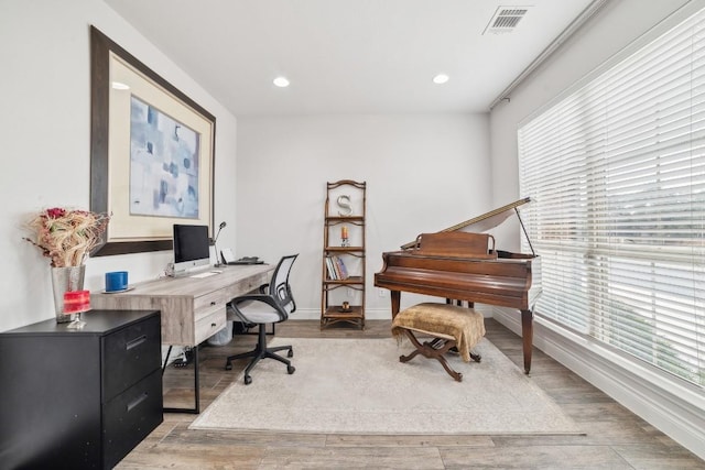 office space featuring recessed lighting, visible vents, light wood finished floors, and baseboards