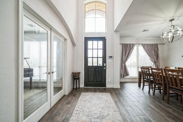 entryway featuring visible vents, baseboards, french doors, an inviting chandelier, and dark wood-style floors