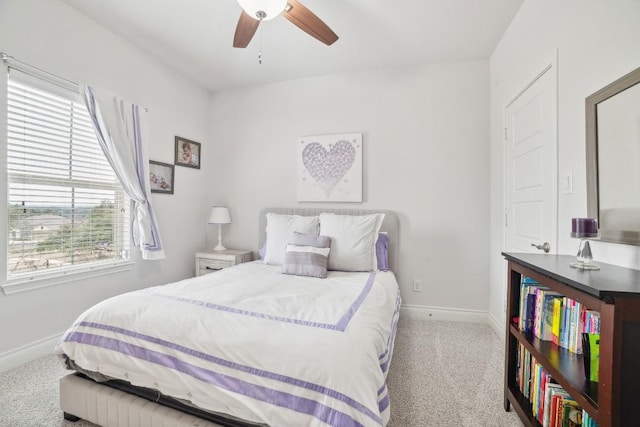 carpeted bedroom featuring ceiling fan and baseboards