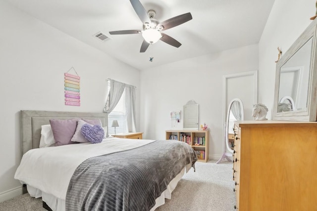 bedroom featuring ceiling fan, light colored carpet, visible vents, and baseboards