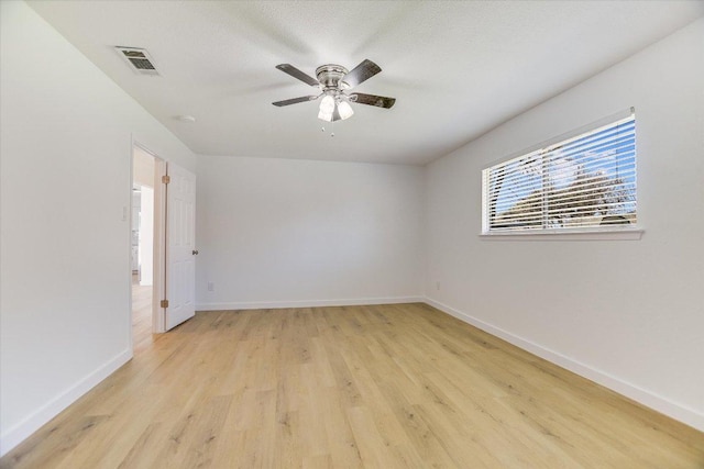 unfurnished room featuring visible vents, baseboards, a ceiling fan, and light wood finished floors