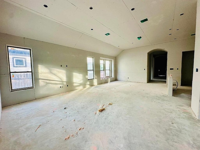 unfurnished room featuring vaulted ceiling