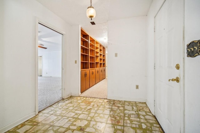 unfurnished room featuring light colored carpet and baseboards