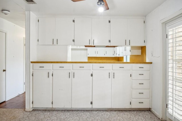 kitchen with light countertops, a ceiling fan, and white cabinetry