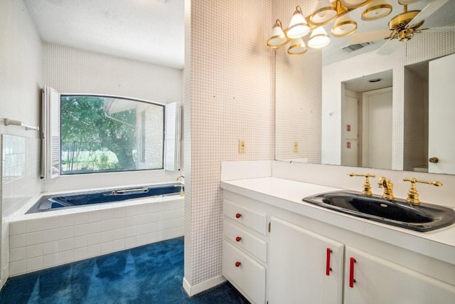 full bath with visible vents, a garden tub, and vanity