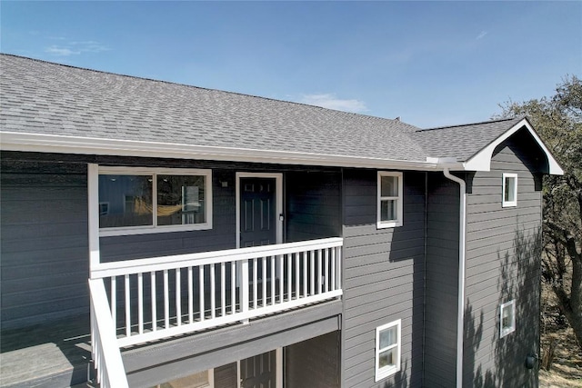 view of home's exterior featuring roof with shingles