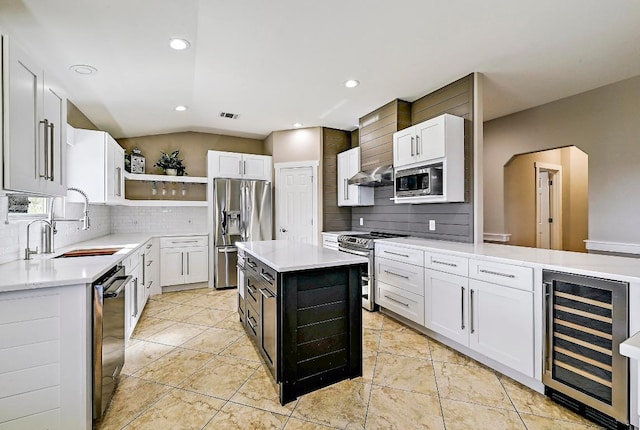 kitchen with open shelves, beverage cooler, light countertops, appliances with stainless steel finishes, and a sink