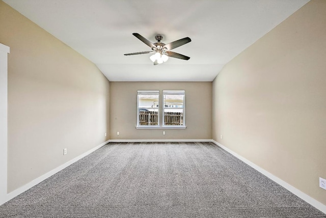 carpeted spare room with baseboards and ceiling fan