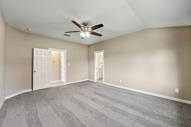 carpeted empty room with visible vents, baseboards, lofted ceiling, and ceiling fan