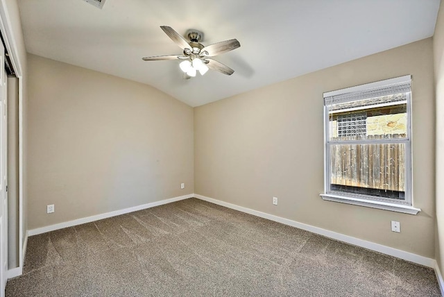 empty room with baseboards, carpet floors, ceiling fan, and vaulted ceiling