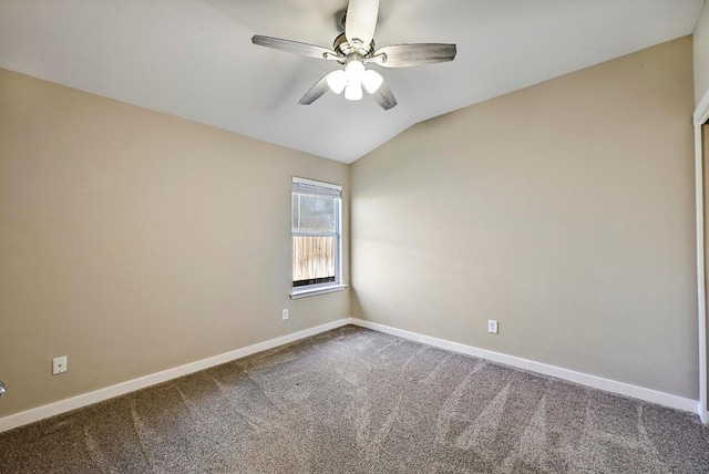 empty room featuring baseboards, lofted ceiling, and carpet flooring