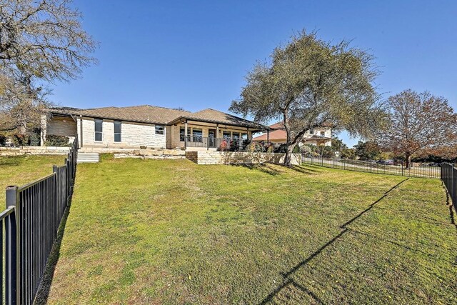 view of front of home with a front lawn and a fenced backyard