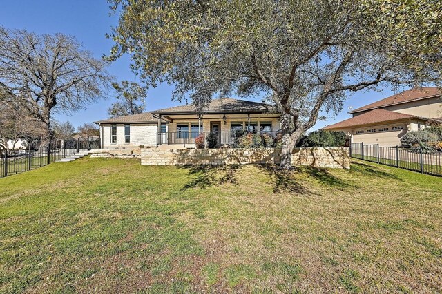 rear view of property with a lawn and fence private yard