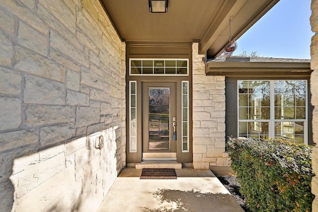 view of exterior entry featuring stone siding