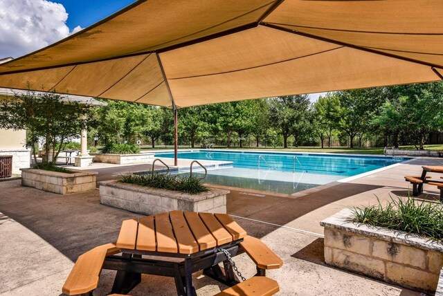 pool with fence and a patio area