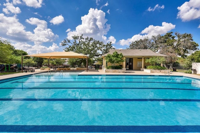 pool featuring a patio area and fence