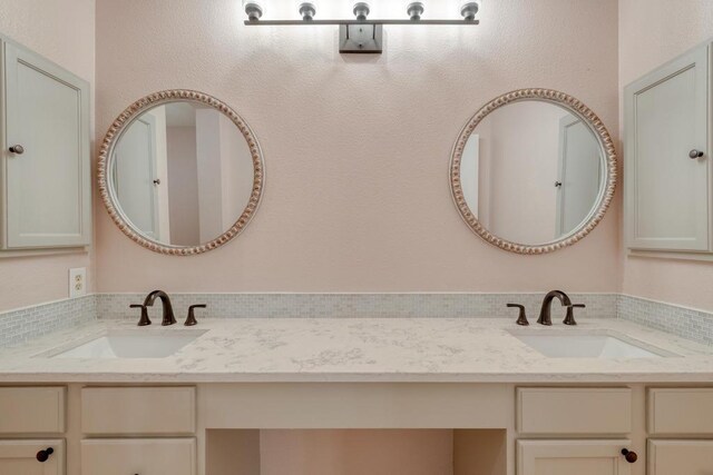 full bath with double vanity and a sink