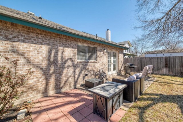 view of patio / terrace with french doors, a grill, and fence