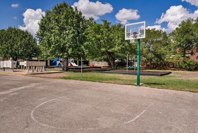 view of basketball court with community basketball court, a lawn, and playground community