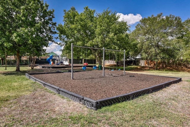 community jungle gym featuring a yard and fence