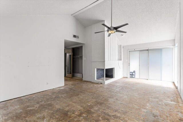 unfurnished living room featuring visible vents, high vaulted ceiling, a ceiling fan, a textured ceiling, and a fireplace