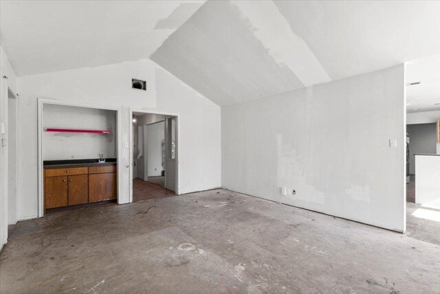 additional living space featuring vaulted ceiling