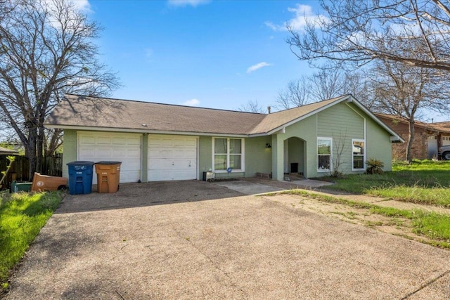 ranch-style home featuring an attached garage and driveway