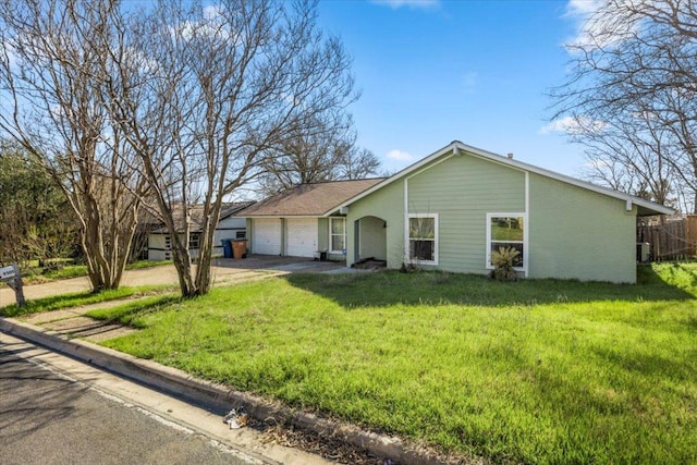 single story home with a front yard, fence, driveway, an attached garage, and brick siding