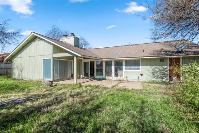 rear view of property featuring a patio and a chimney