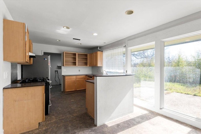 kitchen featuring open shelves, dark countertops, gas range oven, and a sink