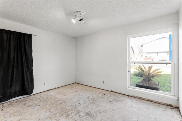 spare room with a textured ceiling