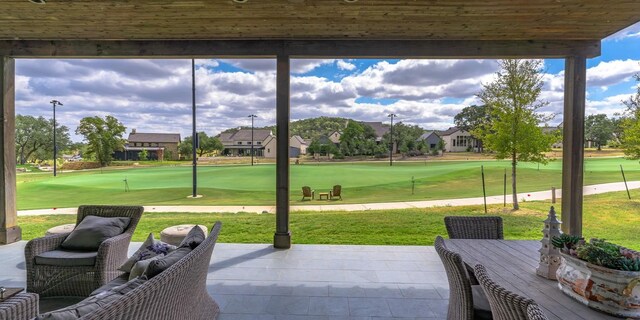 view of patio featuring outdoor dining area and golf course view